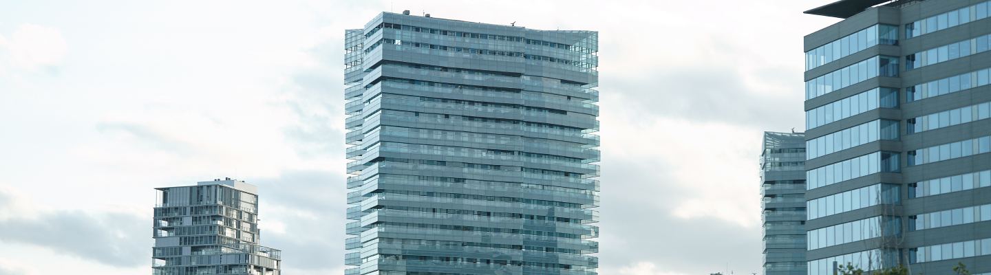 Glass-clad office towers against an overcast sky.